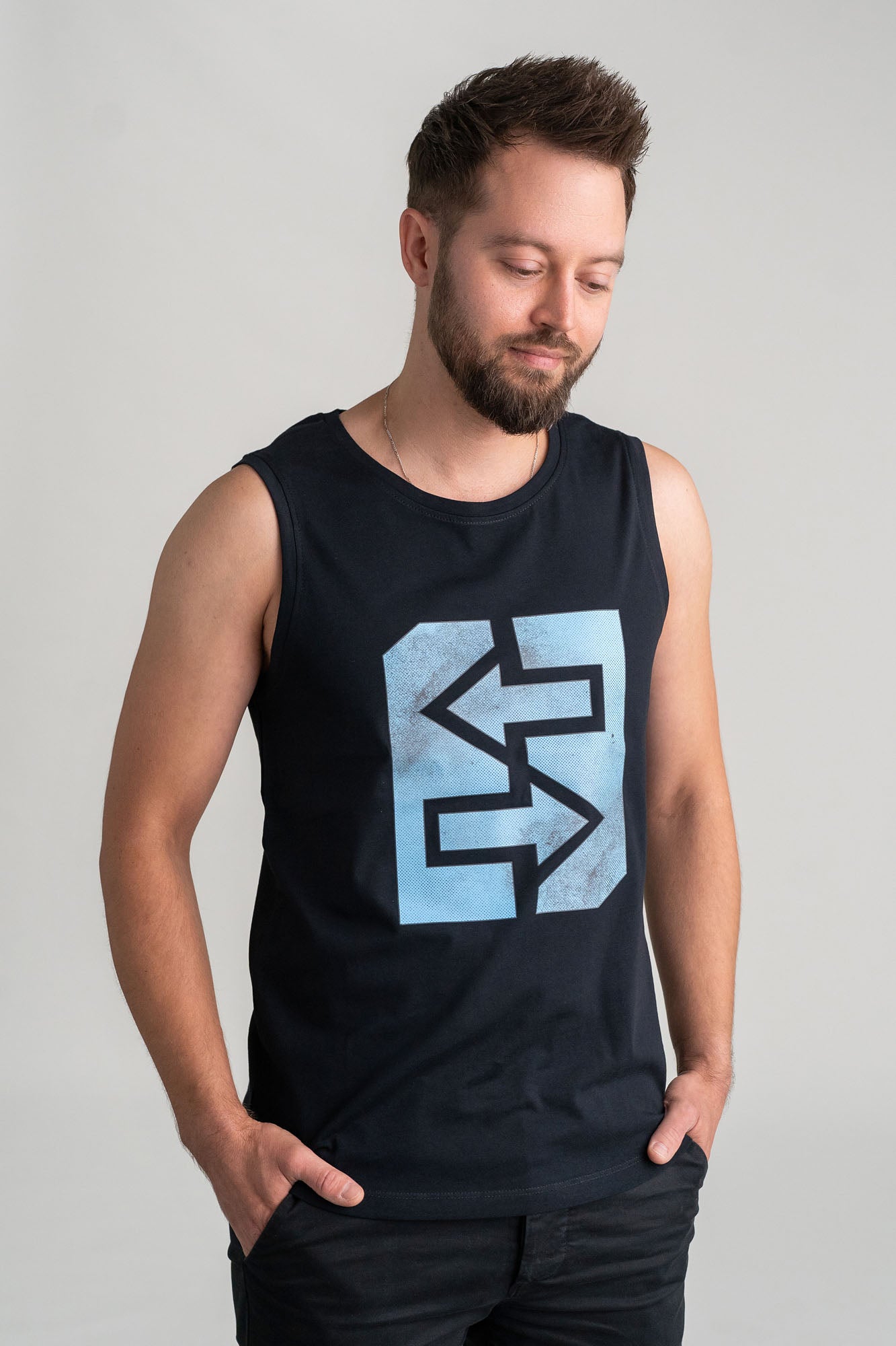 Ein Mann trägt ein Tanktop mit Logo, symbolisiert Stärke und Frische, bereit für Abenteuer und Herausforderungen.